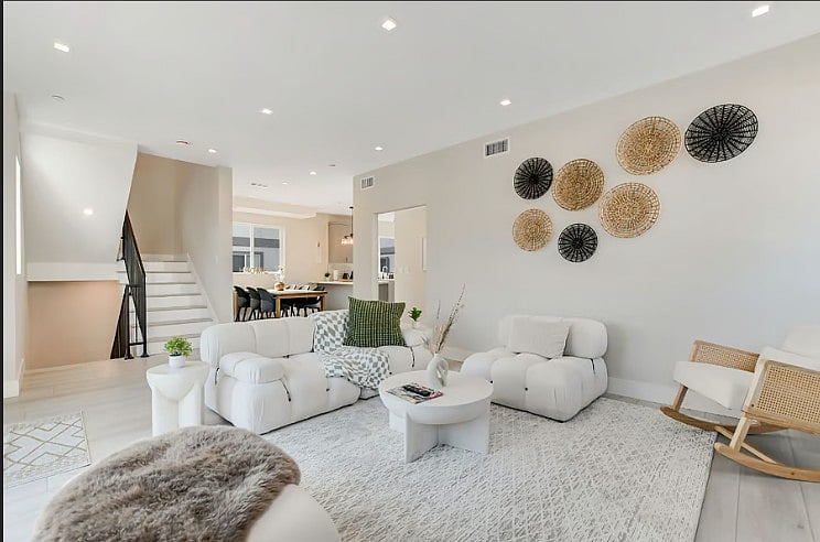 Spacious living room with modern decor, comfortable seating, and a bright open-concept layout.
