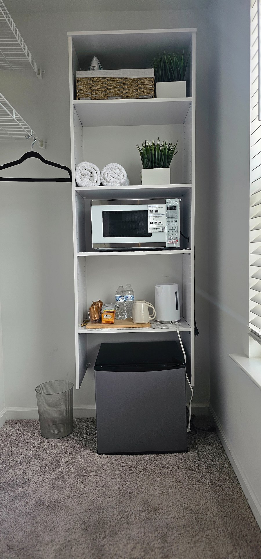 Closet space with mini fridge, microwave, and fridge set up 