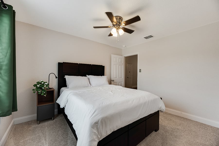 Comfortable queen bedroom that can sleep 2 with soft lighting and a bedside reading lamp perfect for relaxing and unwinding after a full day of fun.