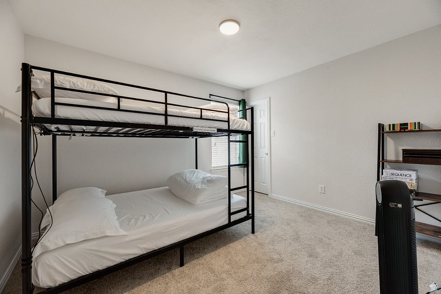 Kid-favorite bunk room featuring a Full-over-Full bed with LED lights, built-in charging station, tower fan, and board games the perfect space for sleepovers and fun!