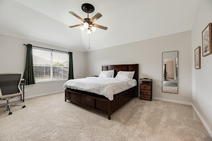 Luxury primary suite with split adjustable King bed that can sleep 2 (Zero Gravity, Head & Foot Massage with individual remotes), 65 Smart TV, and a cozy work desk designed for relaxation and productivity.