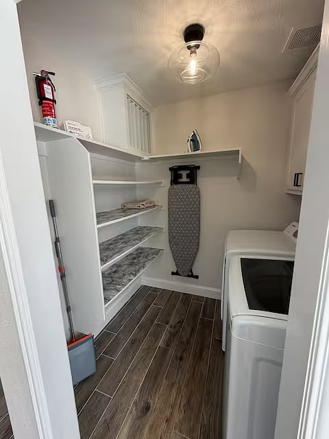 Fully equipped laundry room with washer & dryer, detergent, iron and ironing board, cleaning supplies, first aid kit, and fire extinguisher everything you need for a comfortable and worry-free stay.