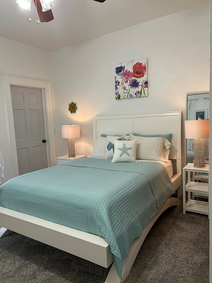 Private bedroom with attached private bathroom. Ceiling fan, closet, clothing steamer.