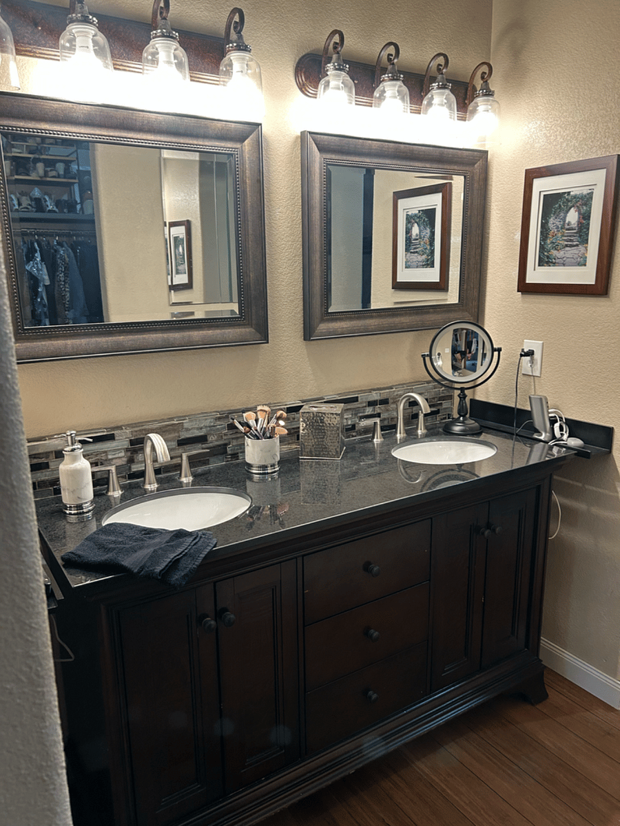 Master bath two sinks plus mirrored medicine cabinets behind and large master walk-in closet