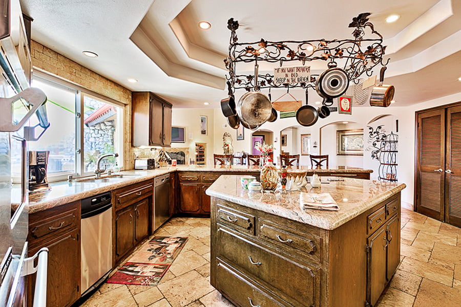 Tuscan kitchen with breakfast bar and center cooking island.Elegant Tuscan Style Kitchen ~ The oversized, open concept kitchen has expansive countertops, cabinets and large center island. Perfect for entertaining.