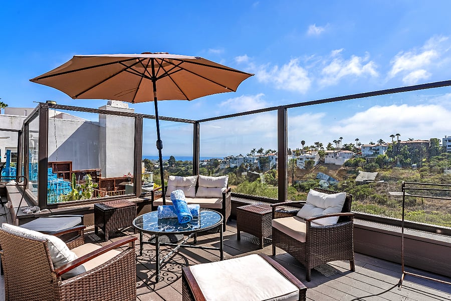 Outdoor seating with canyon and ocean views.