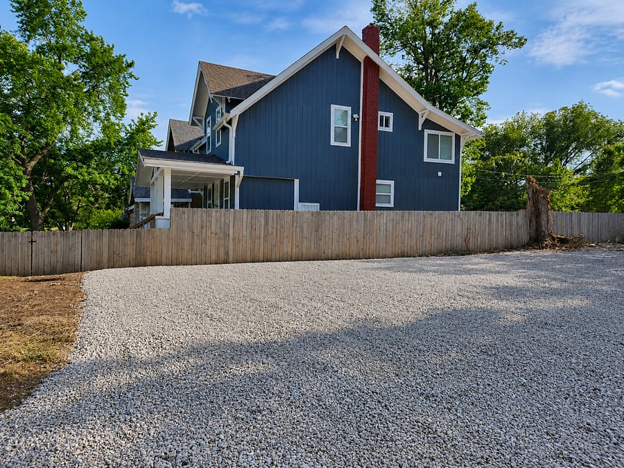 Spacious gravel parking area with easy access to the home and plenty of room for multiple vehicles
