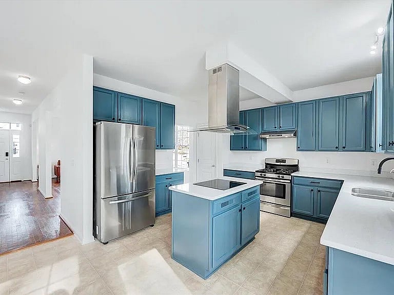 New kitchen with quartz countertop, upgraded cabinets, recently painted, and the color of the year cloud dancer on the walls