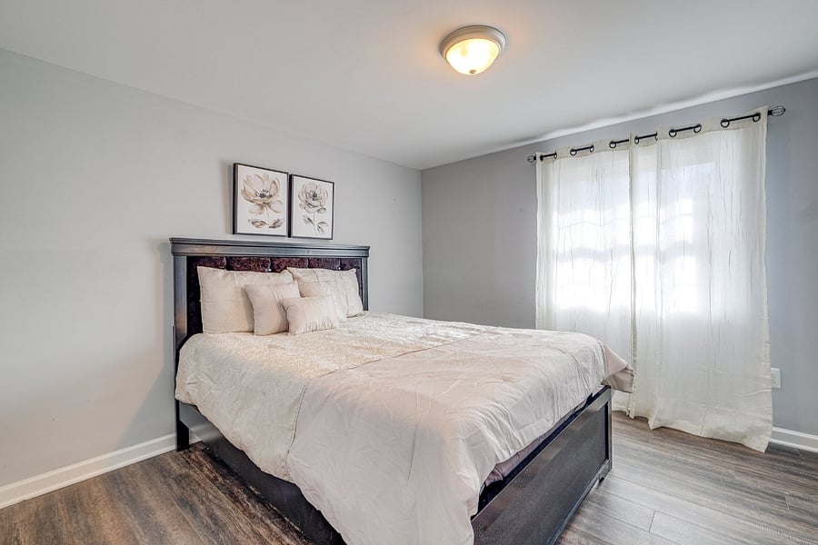 Comfortable Bedroom 4 in the basement with a bright and welcoming street view
