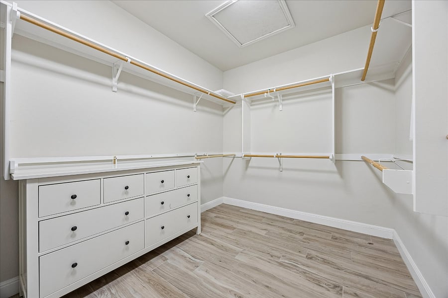 Large master closet with plenty of shelving, space for hanging clothes, and also has a safe for your use. 