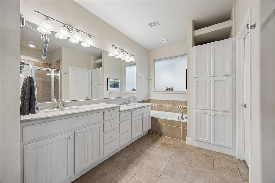 Spacious master bathroom with stunning quartzite countertops, large soaking tub, and separate large separate shower.