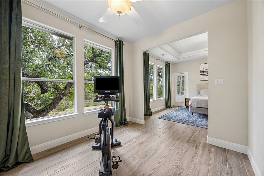 Exercise bike in room attached to master bedroom which can be swapped for twin arm chairs or a desk. Perfect place to enjoy a morning ride, a cup of coffee, or a great place to knock out all the tasks of the day with a desk that can be brought in from the 4th bedroom! 