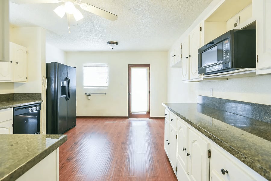 Kitchen with side-by-side fridge and dishwasher