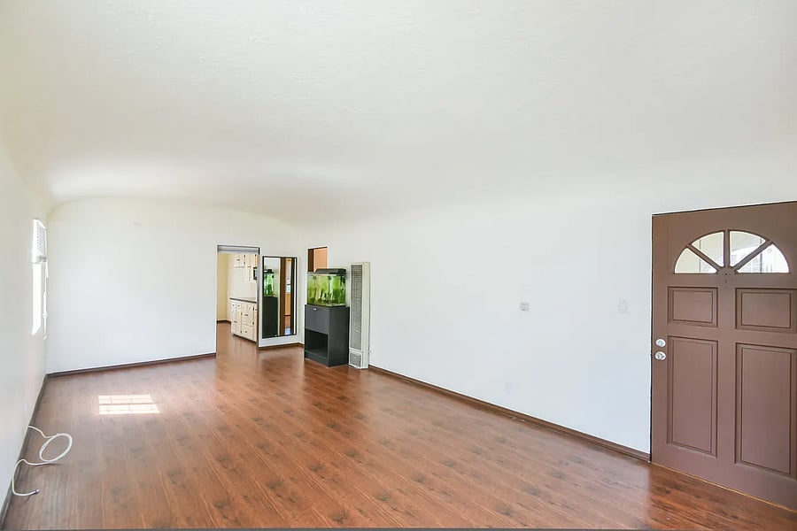 Living room with hardwood floors and arched window