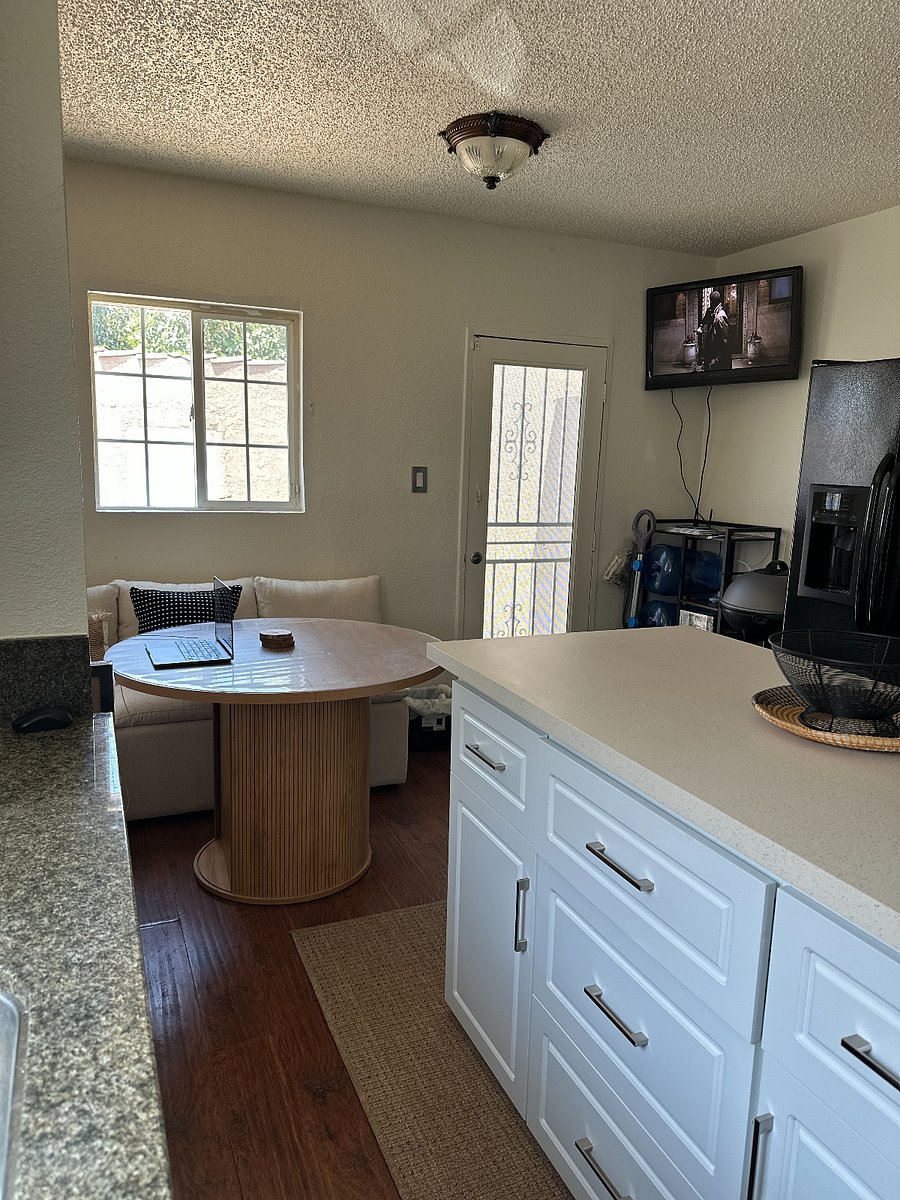 Side-by-side fridge, bottled water cooler, TV, and indoor grill.