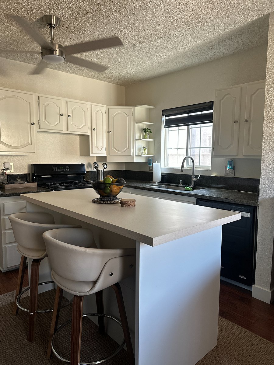 Full kitchen with gas range, microwave, coffee bar, and ample cabinet storage.