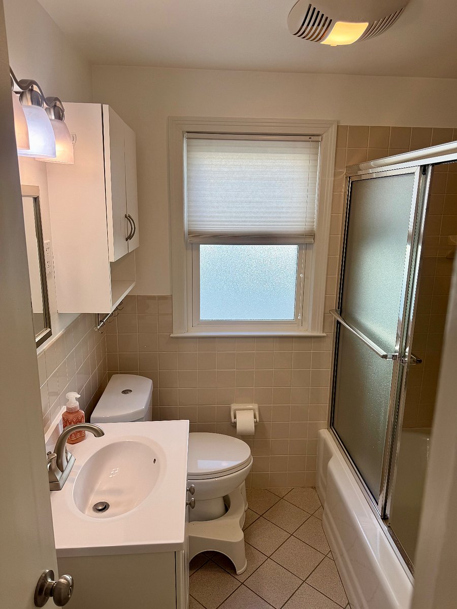 Main floor full bathroom. Mirrored shower door.