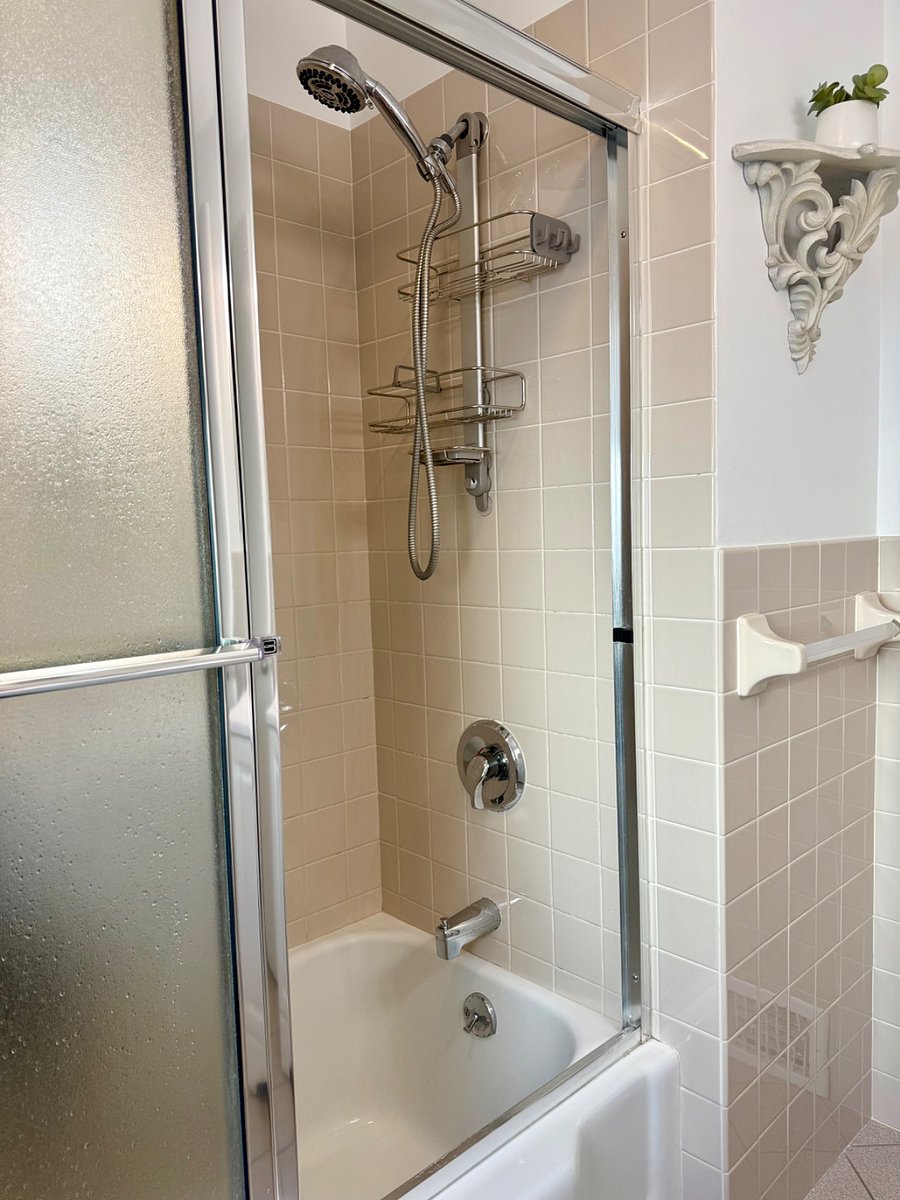 Main floor full bathroom. Mirrored shower door.