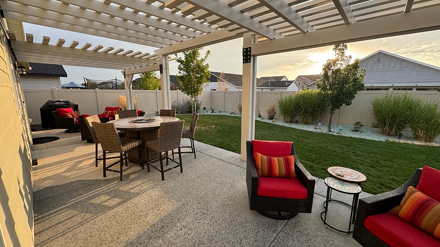 Padded furniture and high-top table with fire pit.