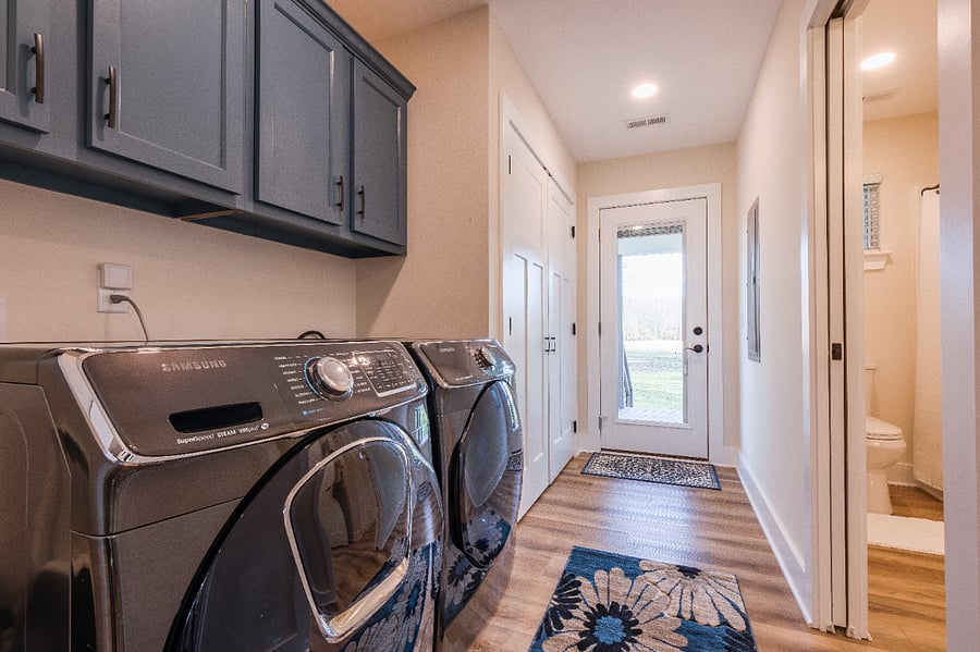 Hallway includes large storage closet that also holds a whole-house water filter system.  Door leads to beautiful screened-in porch and private backyard.