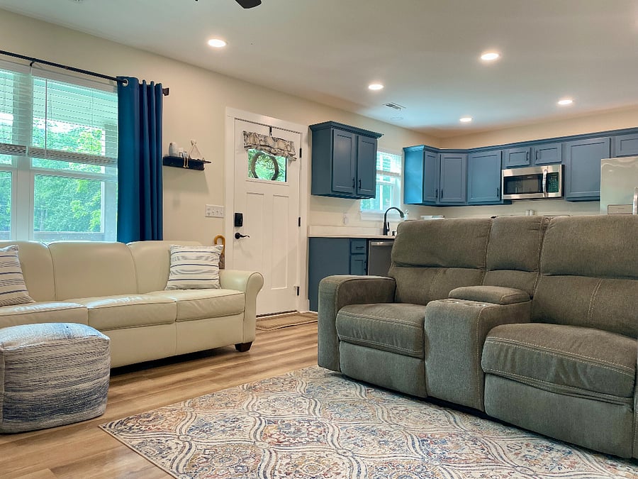 Open concept living room and kitchen.  Comfortable electric reclining loveseat and leather queen sleeper sofa.