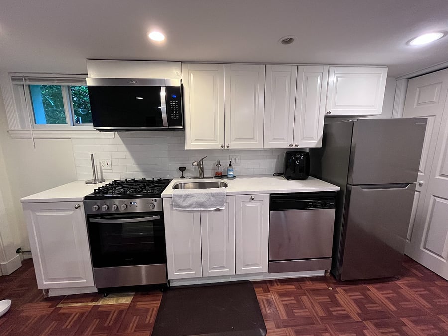 Kitchen with full fridge, stove, and dishwater