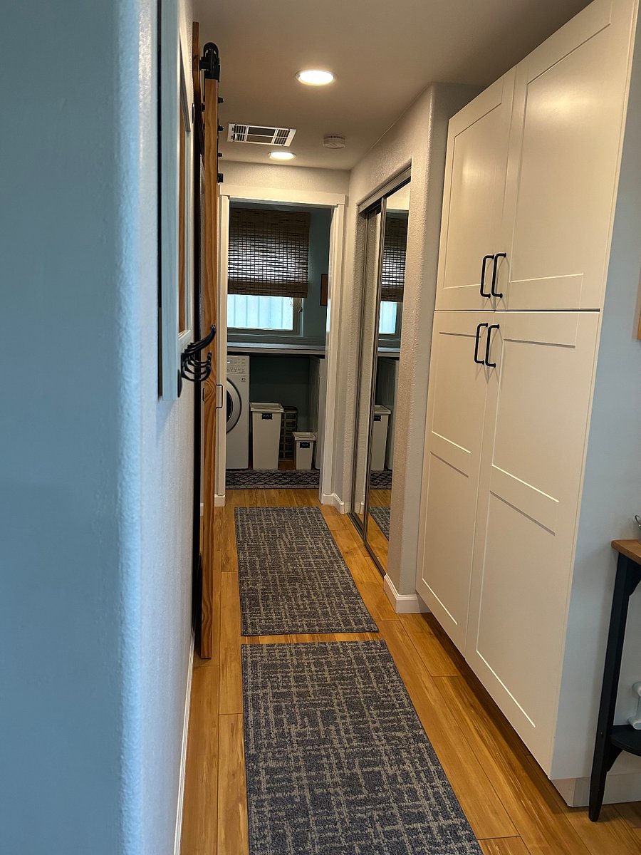 Wide hallway with pantry, extra storage closet on the way to laundry room and bedroom/bathroom