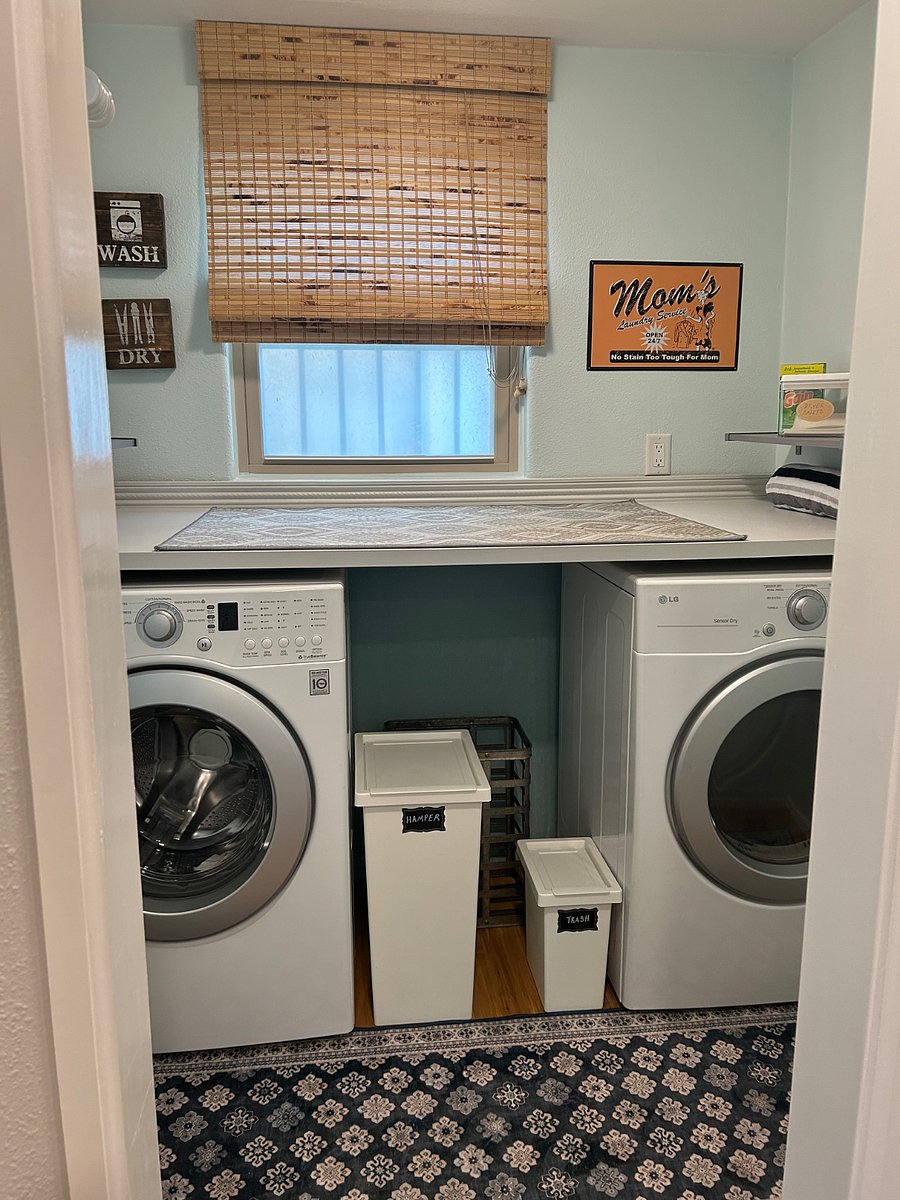 Full laundry room with folding counter and hanging rod
