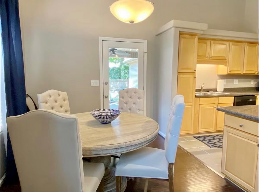 Dining table with 6 chairs. Chairs have been changed to white wooden chairs instead of the fabric chairs shown.