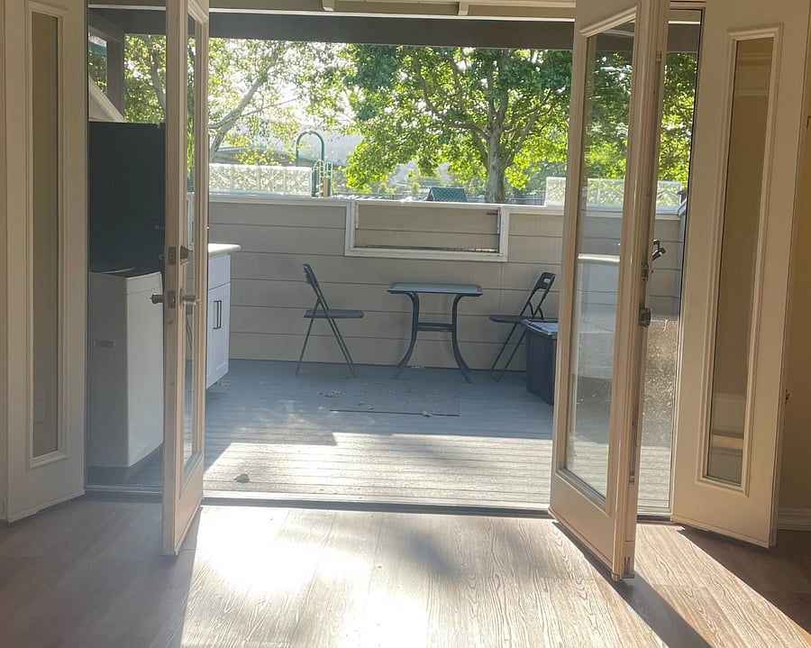French doors to a 130 sq ft private deck. Small clothes washer and second fridge {left) .