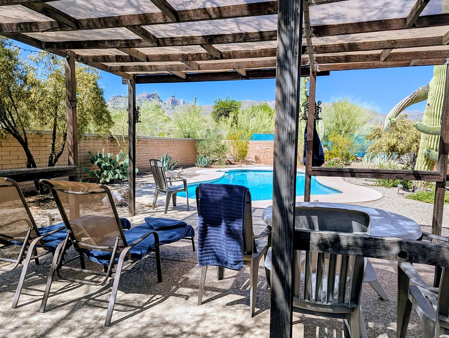 Outdoor patio next to the pool with shades 