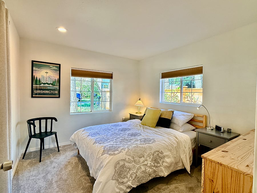 Second queen bedroom with plenty of light, dresser, and closet. 