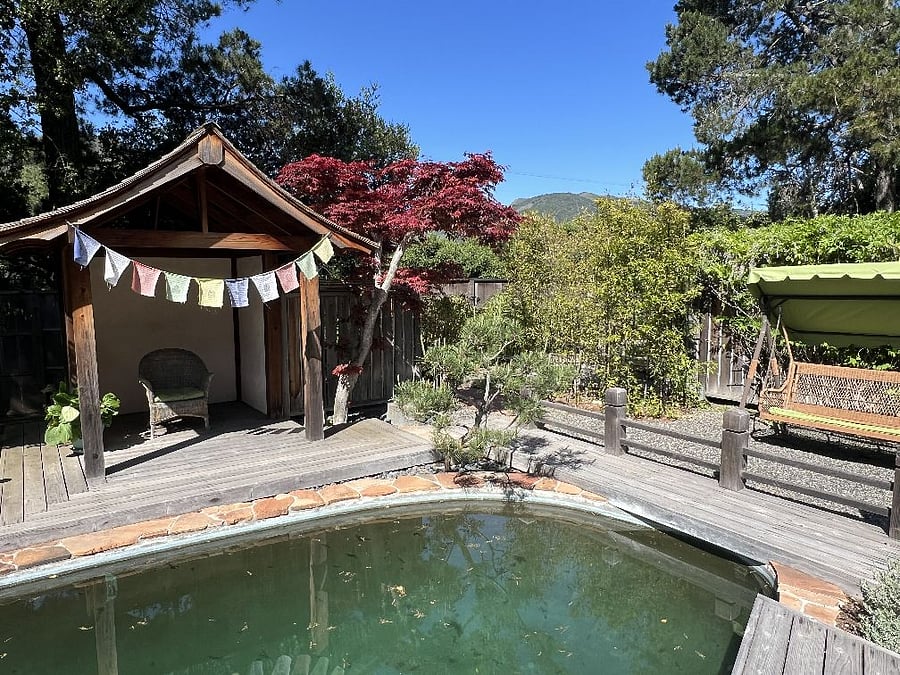 Tea house and outdoor swing seat by pool.