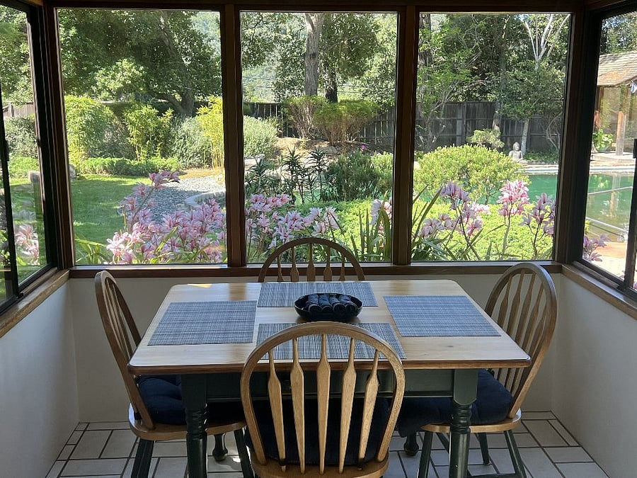 Breakfast nook overlooks front garden and pool.