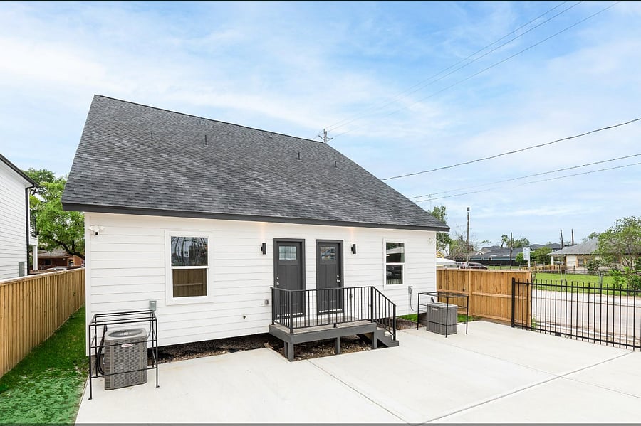 Back of the home where parking is located. Fully gated