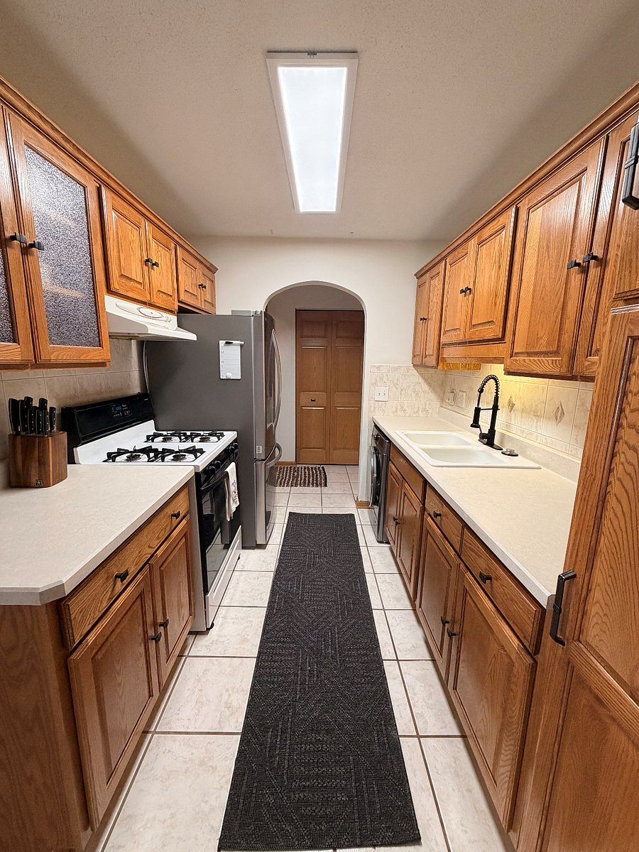 Full kitchen with gas oven. Microwave is stored.