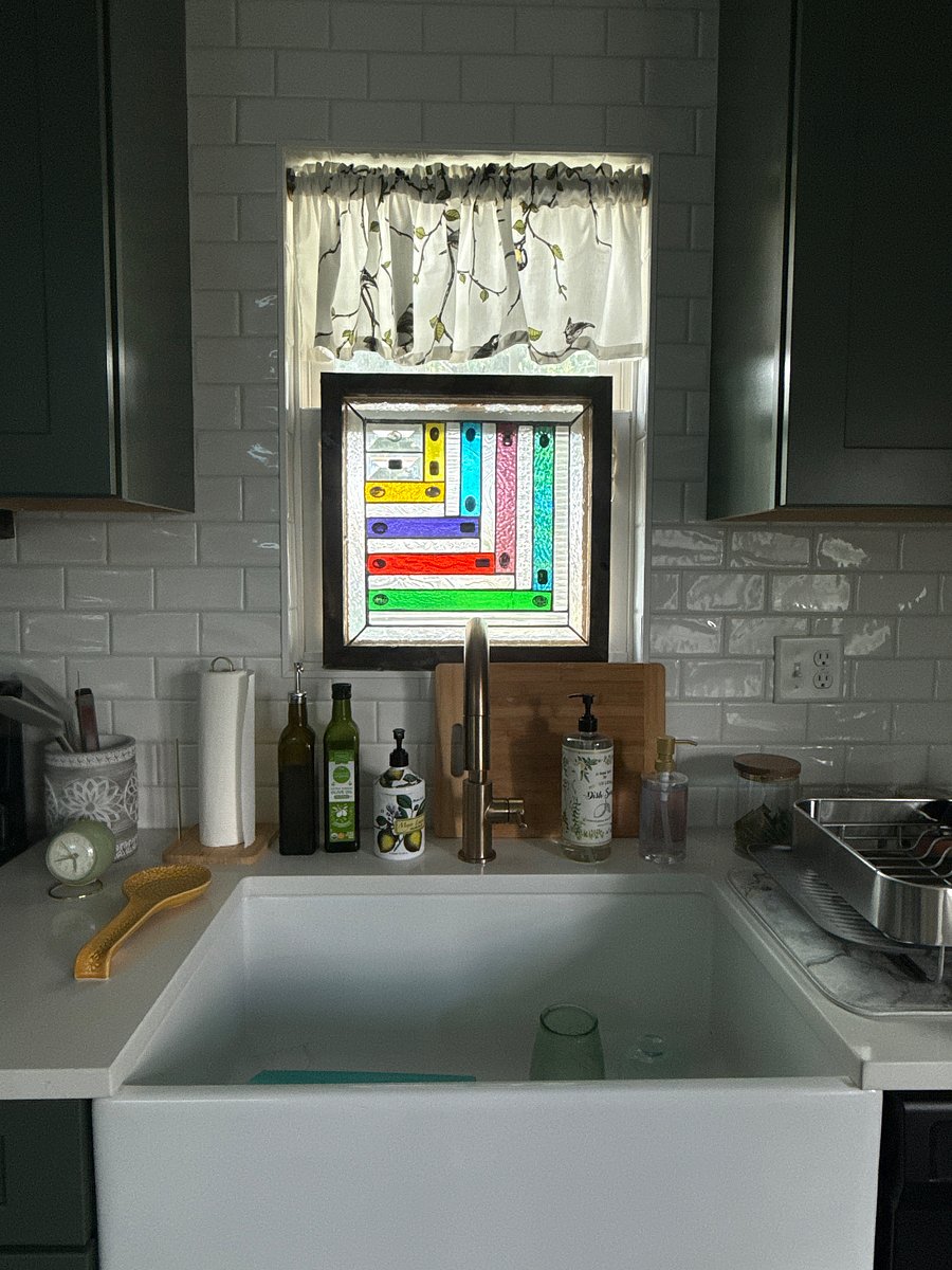 Unique stained glass window attached to the original window