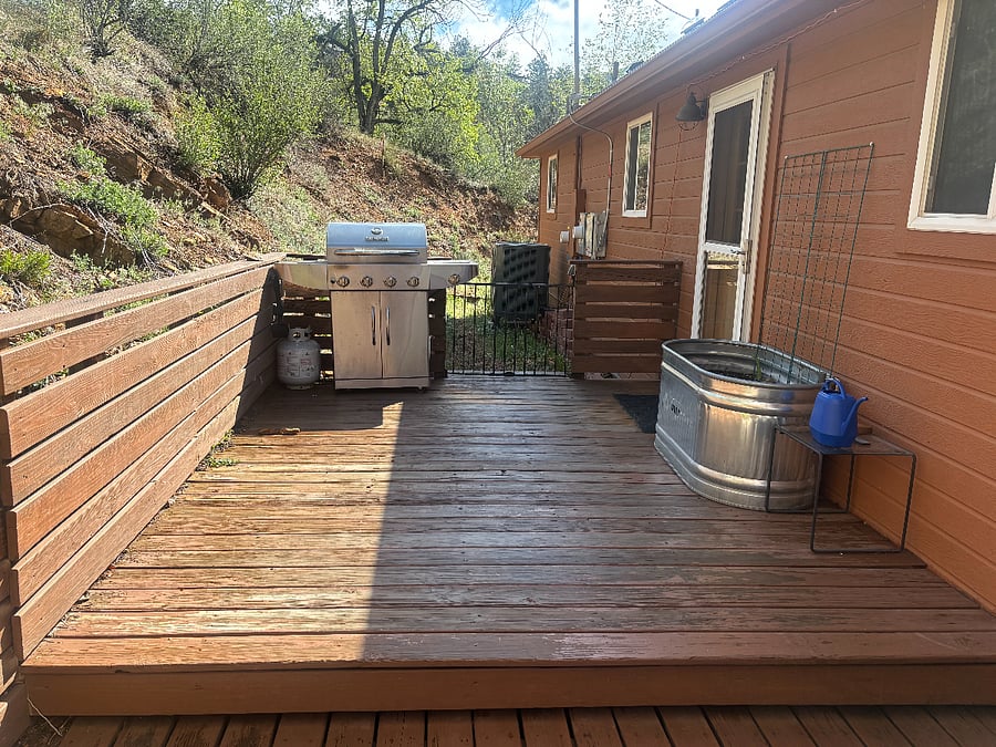 Back deck with gas grill connects to the kitchen for easy access.