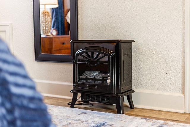Primary bedroom includes a space heater that emits heat and light, like a fireplace. It's very cozy!