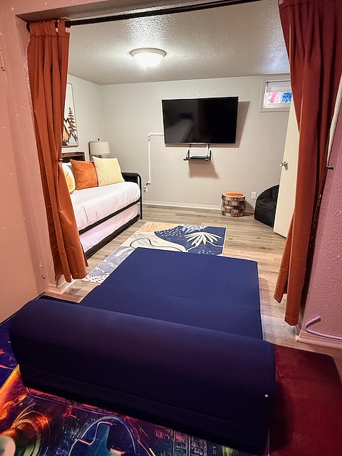 The small couch in the arcade can unfold into a bed/lounging area for small children. You can move it around to face the TV in the bedroom too.