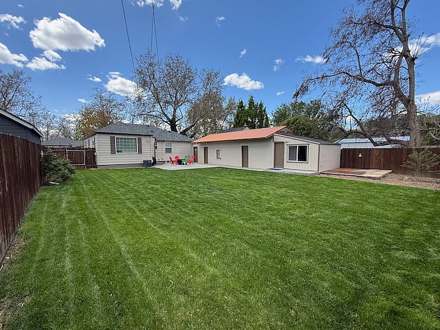 Spacious, fenced backyard. Includes fire pit, 4 chairs, and a Weber grill with tools.