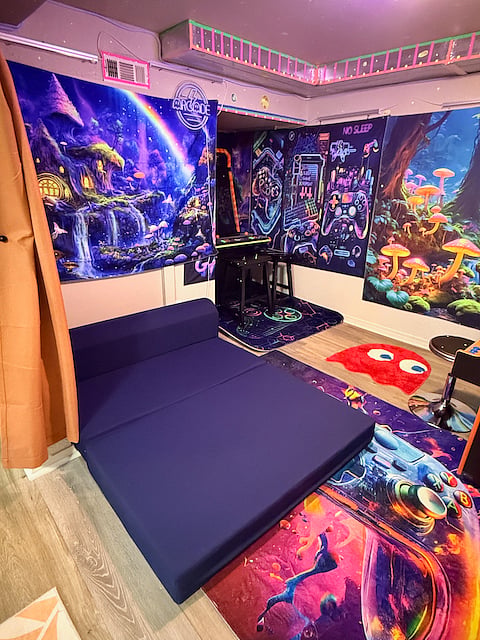 The small couch in the arcade can unfold into a bed/lounging area for small children.