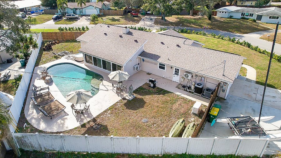 Aerial of backyard with pool, hot tub, and fire pit.