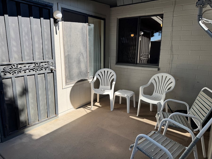 Cozy and shaded back patio comes with a grill