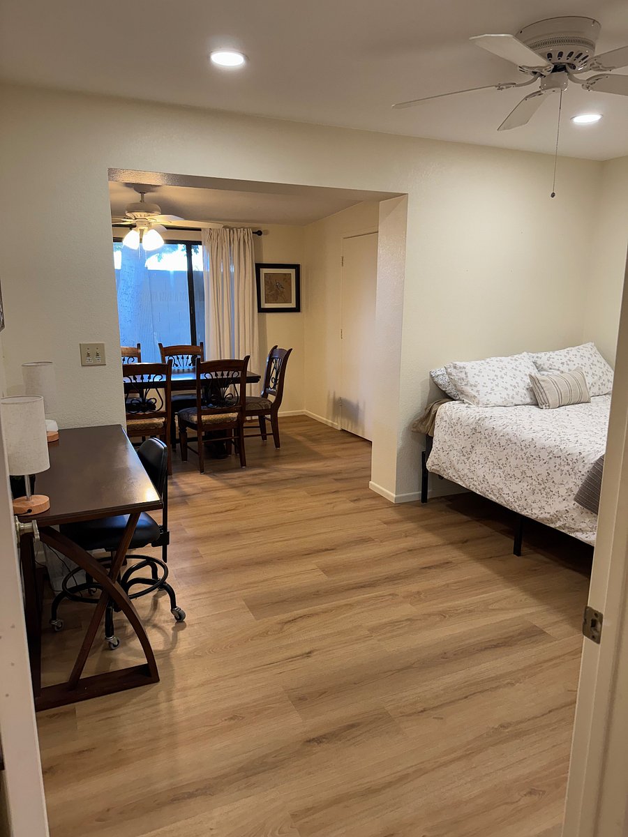 Back rooms doubles as guest bedroom with queen bed and office space. Opens to dining rooms for entertaining. Second full bath located nearby. 