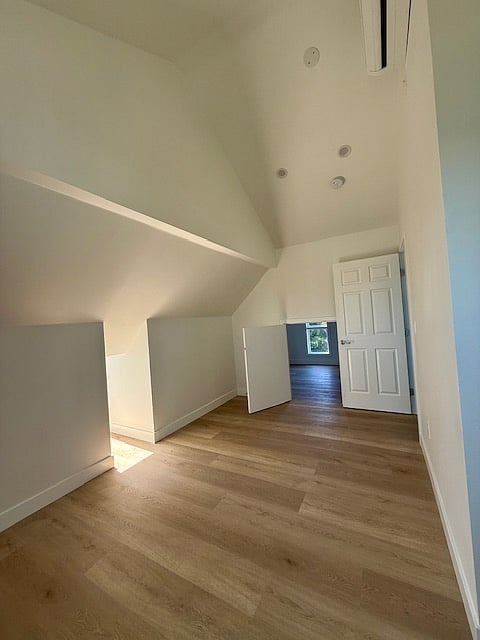 multi-purpose space I upstairs bedroom #3 with finished attic access. vaulted ceilings.