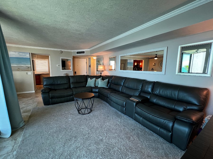 View of the living room looking towards the entrance and kitchen.