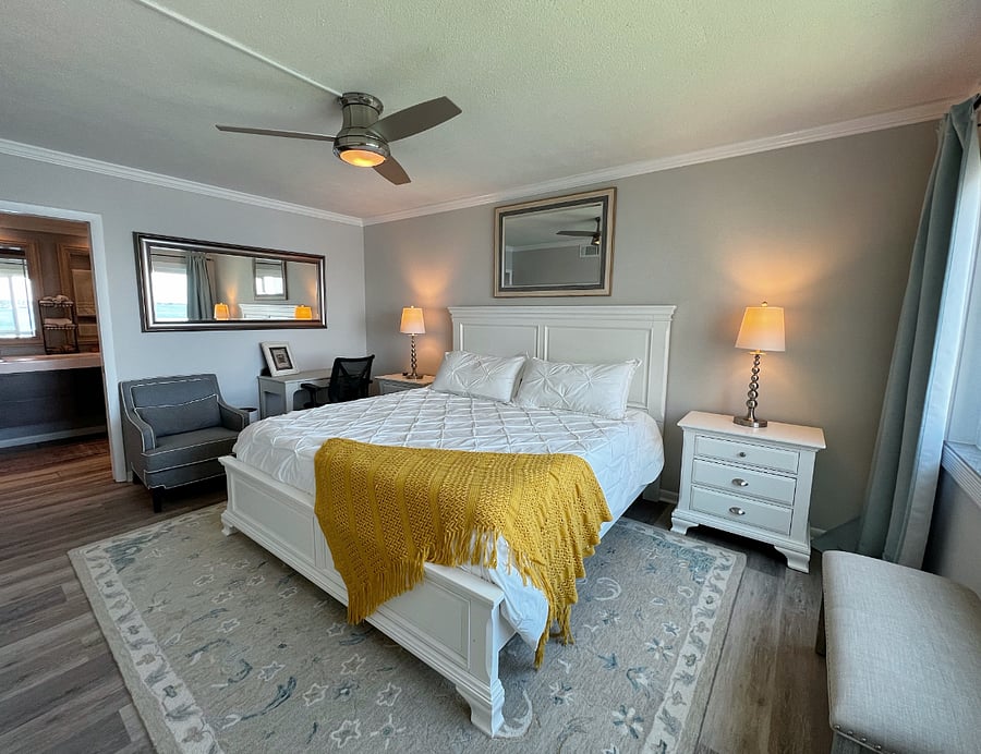 Master suite with a king sized bed and private attached bathroom.
