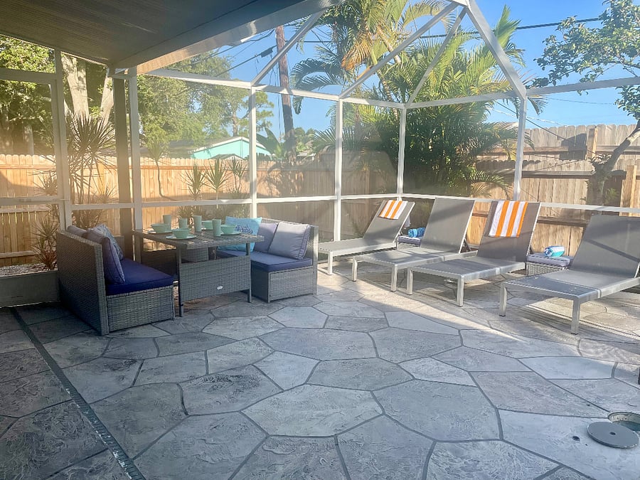 Outdoor patio space with loungers and dining table. 