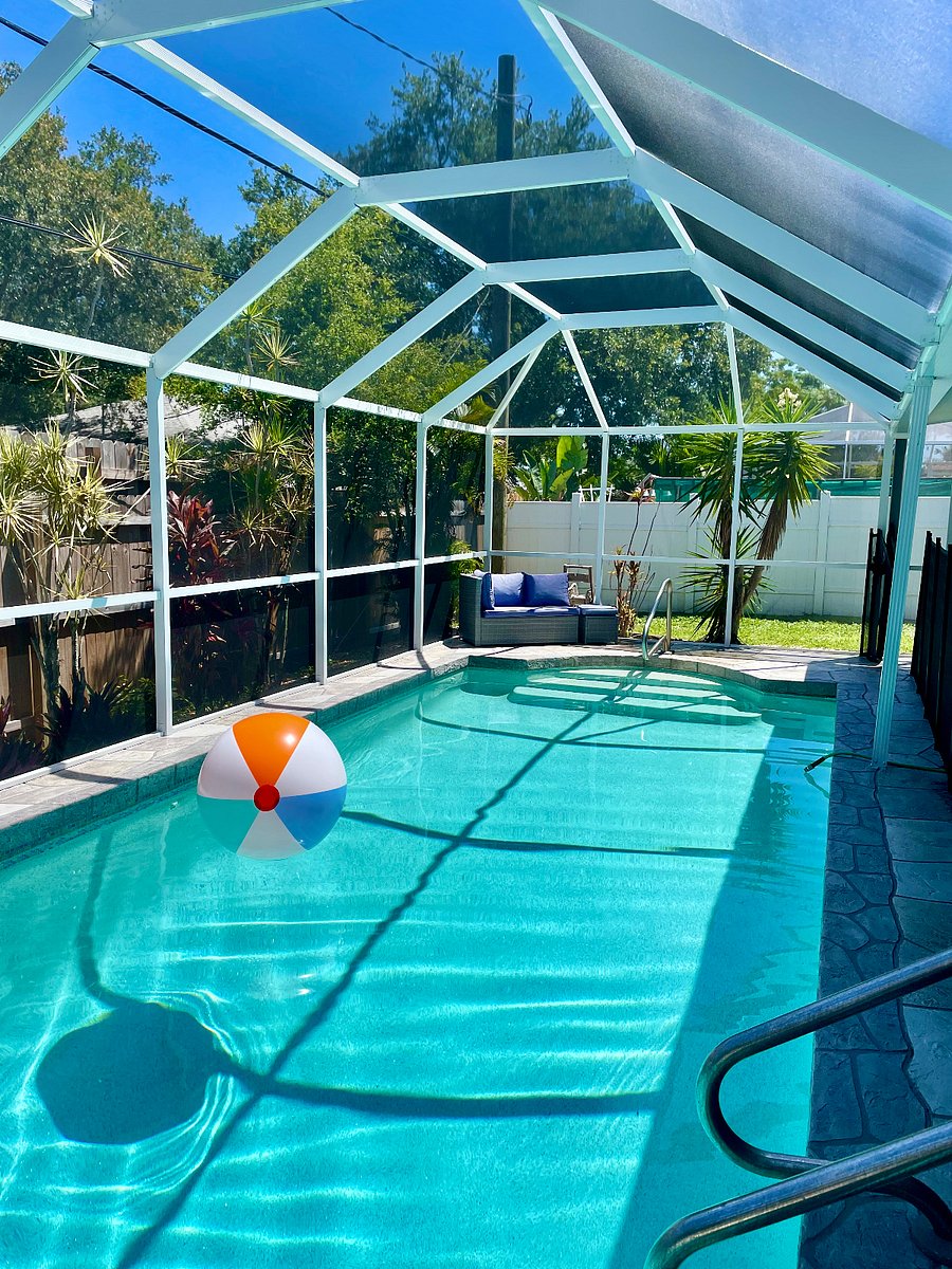 Outdoor pool with screened in lanai.